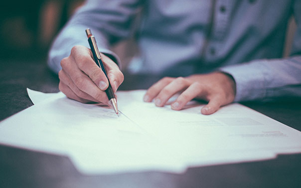 Employee signing legal documents